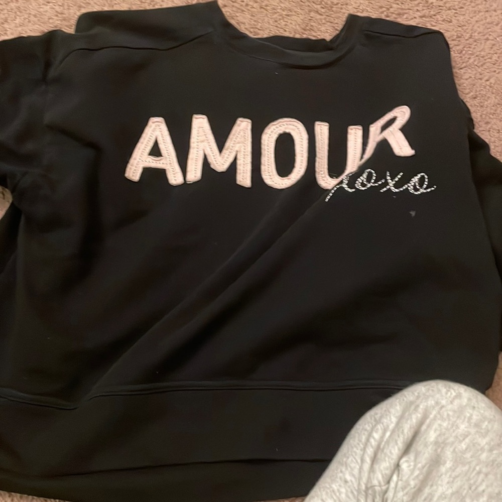 It is a black sweatshirt with pink font bold letters
